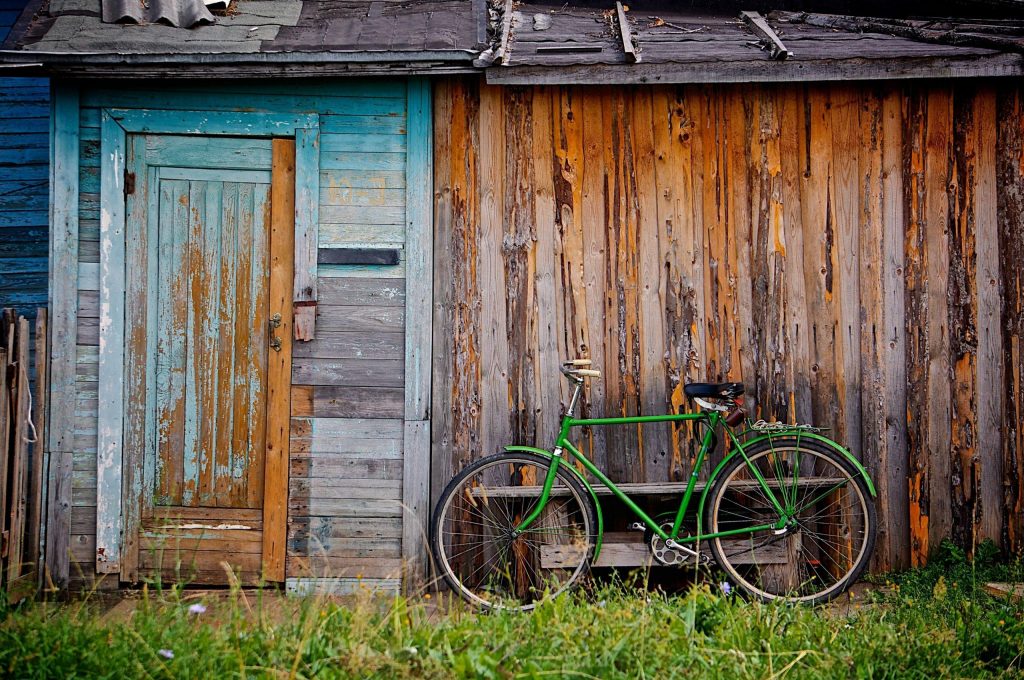 old wooden cottage and bicycle scaled